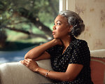 Free Stock Photo: An African-American woman looking out a window