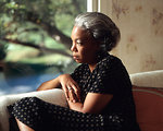 Free Stock Photo: An African-American woman looking out a window