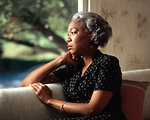 Free Stock Photo: An African-American woman looking out a window