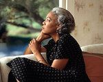 Free Stock Photo: An African-American woman looking out a window