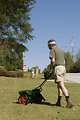 Free Stock Photo: A man fertilizing his lawn with a spreader