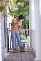 Free Stock Photo: A woman sweeping her front porch