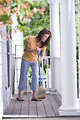 Free Stock Photo: A woman sweeping her front porch