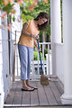 Free Stock Photo: A woman sweeping her front porch
