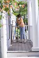 Free Stock Photo: A woman sweeping her front porch
