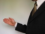 Free Stock Photo: Business man in suit holding his hand out