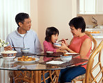 Free Stock Photo: An Asian family eating a meal at the table
