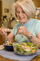 Free Stock Photo: A woman eating a fresh salad