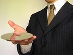 Free Stock Photo: Business man holding a comopact disc