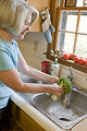 Free Stock Photo: A woman preparing a salad in her kitchen