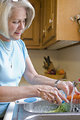 Free Stock Photo: A woman preparing a salad in her kitchen