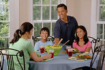 Free Stock Photo: An Asian family eating dinner at a table