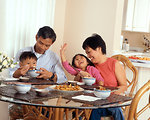 Free Stock Photo: An Asian family eating a meal at the table