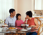Free Stock Photo: An Asian family eating a meal at the table