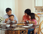 Free Stock Photo: An Asian family eating a meal at the table