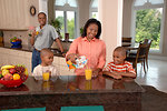 Free Stock Photo: An African-American family in a kitchen drinking juice