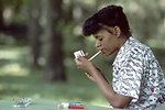 Free Stock Photo: An African American woman lighting a cigarette