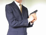 Free Stock Photo: Man in a suit with a small pistol