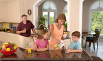 Free Stock Photo: A family drinking juice in the kitchen