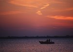 Free Stock Photo: A fisherman in a boat on a lake