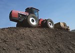 Free Stock Photo: A tractor moving topsoil on a hill