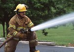 Free Stock Photo: A firefighter with a water hose