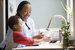 Free Stock Photo: A young boy learning how to wash his hands