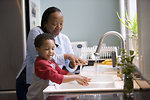 Free Stock Photo: A young boy learning how to wash his hands