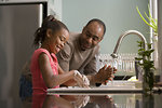 Free Stock Photo: A young girl learning how to wash her hands