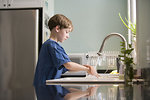 Free Stock Photo: A young boy washing his hands