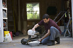 Free Stock Photo: A man working on his lawnmower