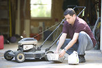 Free Stock Photo: A man working on his lawnmower