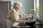 Free Stock Photo: An elderly woman washing produce