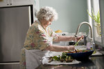 Free Stock Photo: An elderly woman washing produce