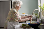 Free Stock Photo: An elderly woman washing produce