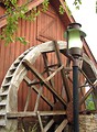Free Stock Photo: Red barn with dry water wheel and lamp post