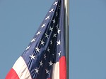 Free Stock Photo: A US flag hanging on a flag pole