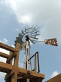 Free Stock Photo: An old farm windmill in a blue cloudy sky