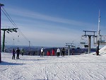 Free Stock Photo: Skiers and chair lifts at the top of a mountain
