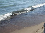 Free Stock Photo: Closeup of small waves breaking on the beach