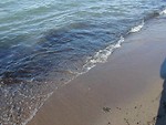 Free Stock Photo: Closeup of small waves breaking on the beach