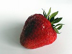 Free Stock Photo: Closeup of a large red strawberry on white background