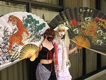 Free Stock Photo: Two teen girls in anime costumes posing with fans at Dragoncon 2008