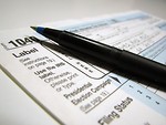 Free Stock Photo: Closeup of a 1040 tax form and a pen