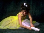 Free Stock Photo: A ballerina doing stretches on the floor