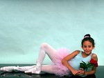 Free Stock Photo: A teen ballerina posing on the floor with a rose
