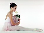 Free Stock Photo: A young ballerina posing on the floor with a yellow rose