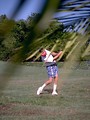 Free Stock Photo: View of a man swinging a golf club through trees