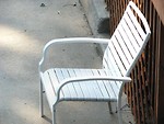 Free Stock Photo: White chair against a fence