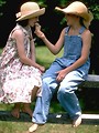 Free Stock Photo: A young boy and girl sharing an ice cream cone on a wooden fence